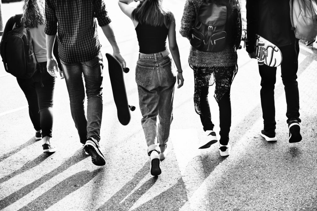 Teens walking away in black and white