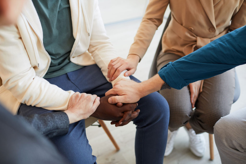 Group showing support by holding hands