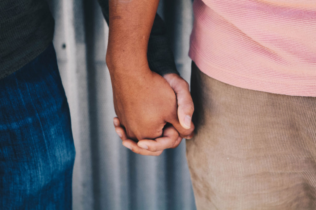 Closeup of couple holding hands