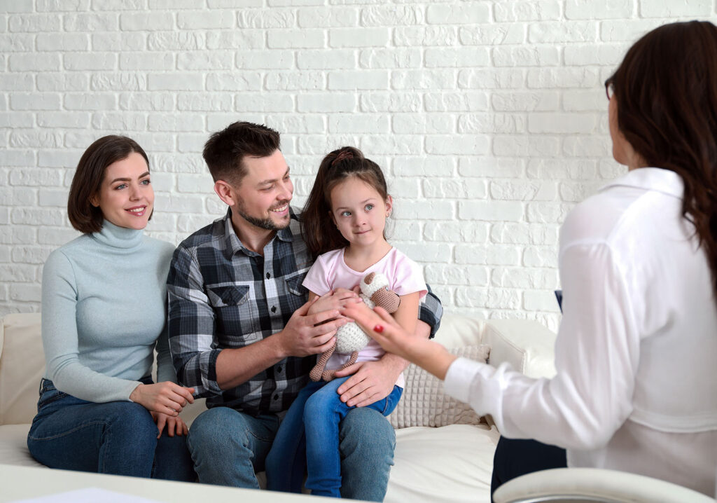 family with little girl in counseling session