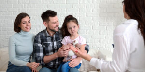 family with little girl in counseling session